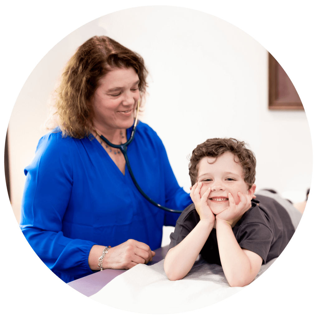 A pediatrician uses a stethoscope on a little girl